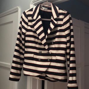 Cream and navy blazer with red stitching.